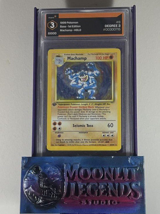 Machamp – 1999 Pokémon Base Set 1st Edition, Holo #8 (Degree 3 Good)